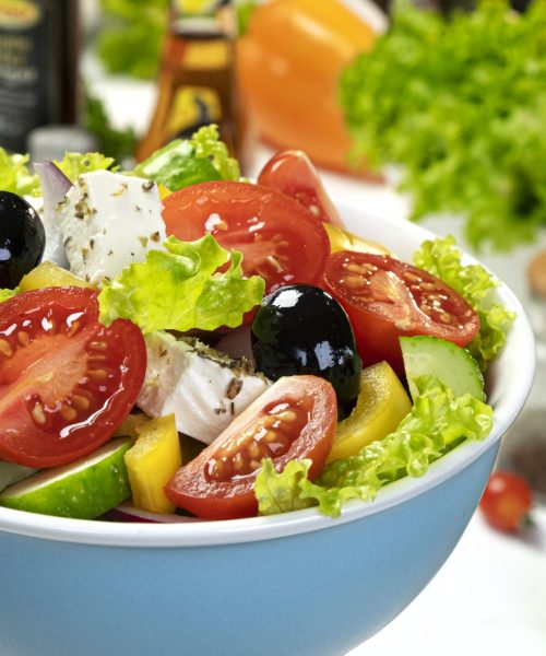 Fresh greek salad served with healthy food ingredients
